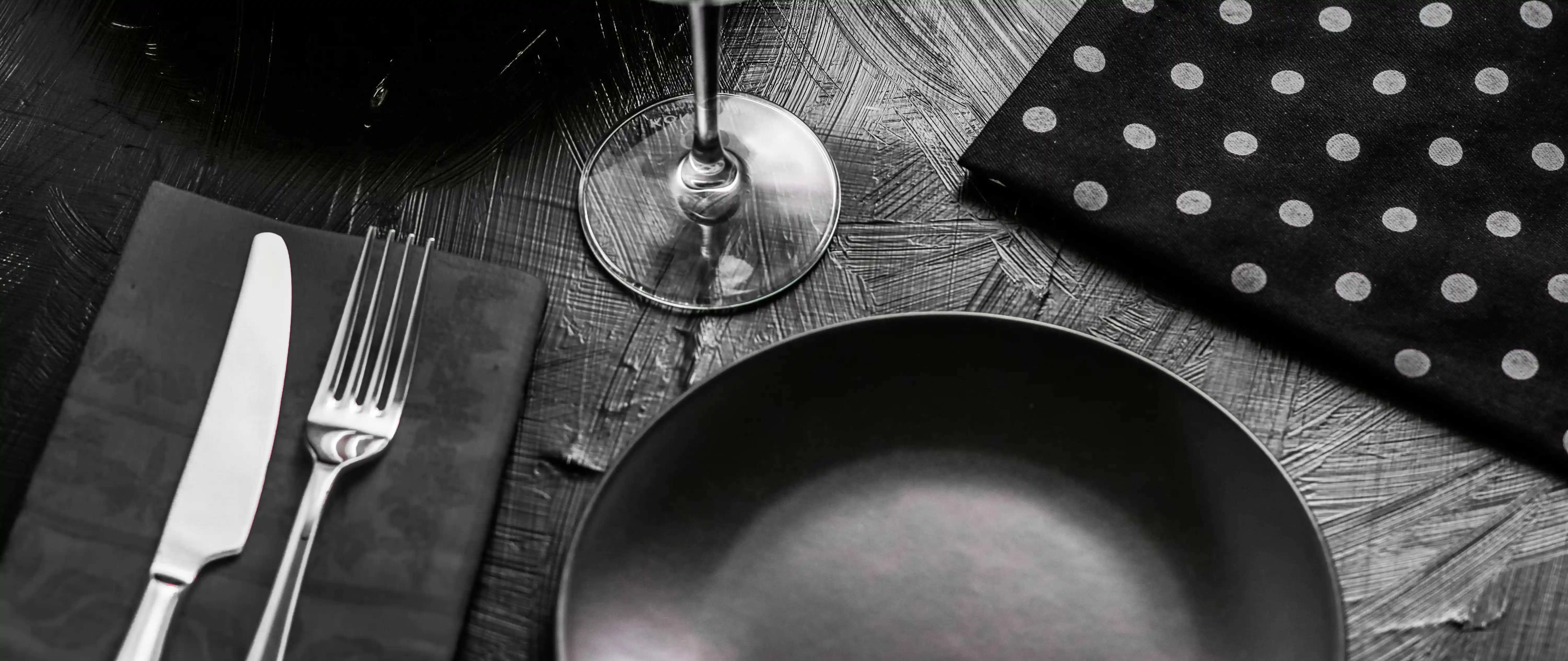 Athletic woman with backpack looking over shoulder on mountain trail above Alpine lake, travel adventure solo women's travel and outdoor exploration